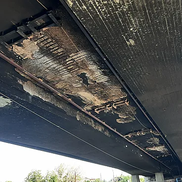 Fire damage and exposed reinforcement on the underside of the Belasica Bridge